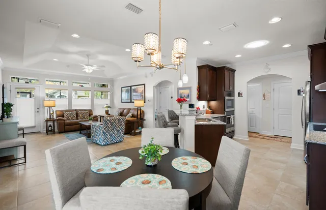 a very nice looking dining room with furniture a kitchen and wooden floor