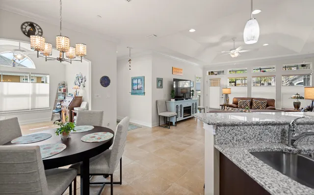 a kitchen with granite countertop a table and chairs in it