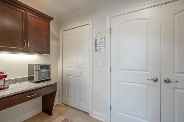 a kitchen with cabinets and stainless steel appliances