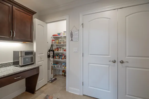 a kitchen with refrigerator and cabinets