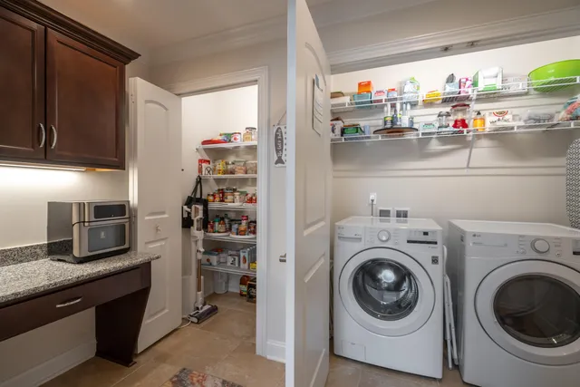a utility room with sink dryer and washer