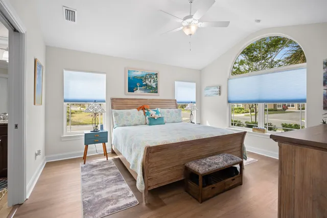 a bed room with a bed and a chandelier