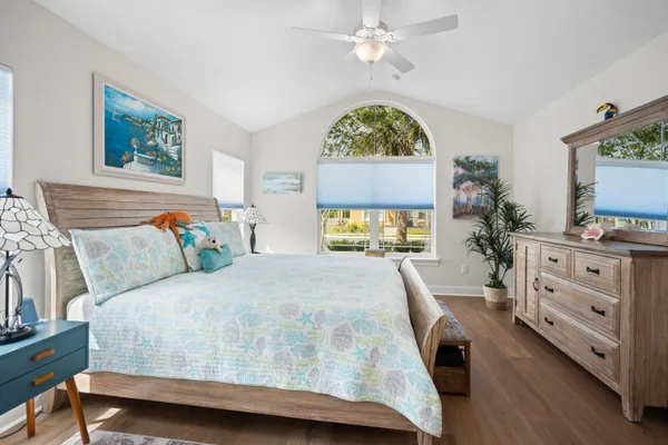 a bedroom with a bed and a flat tv screen on dresser