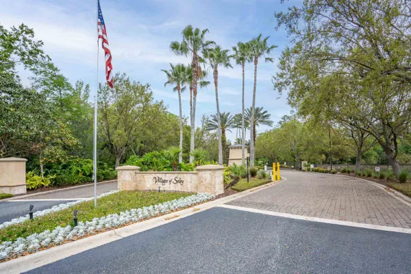a view of a garden with a bench and trees