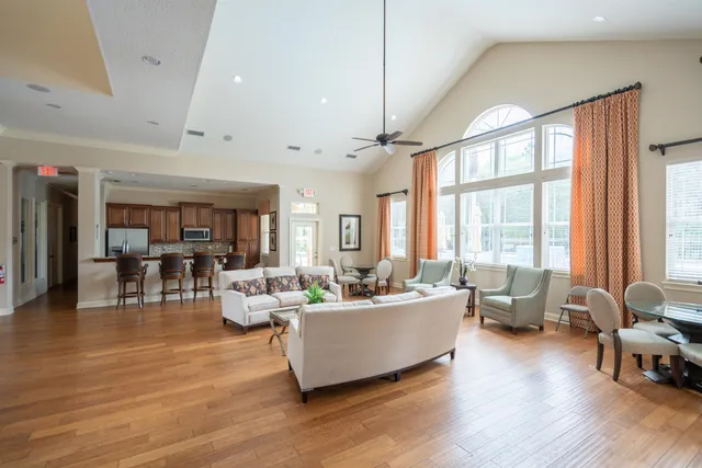 a living room with furniture and large windows