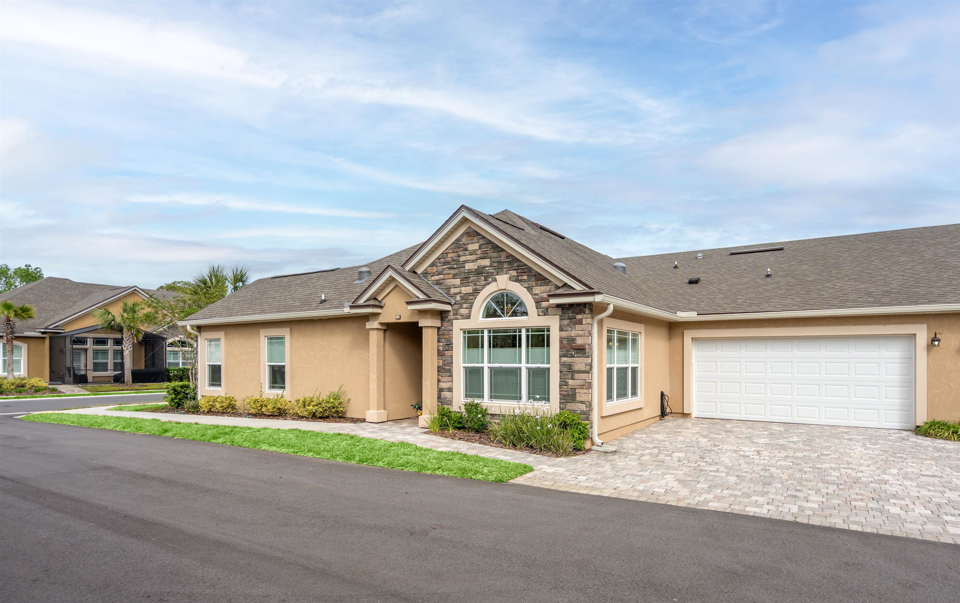 102 Timoga Trail St. Augustine, FL 32084 - Photo 4 of 44 a front view of a house with a garden and trees