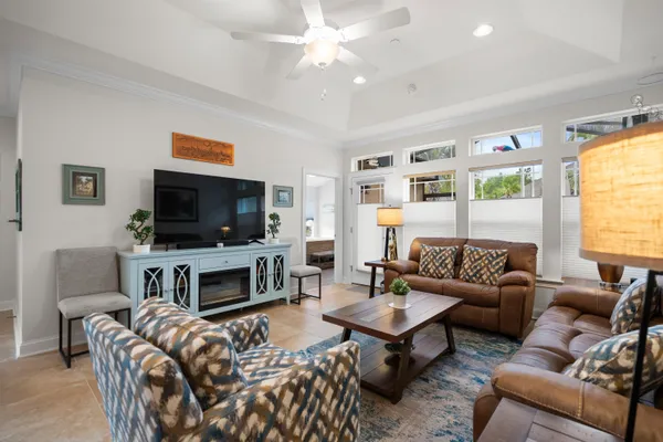 a living room with furniture a flat screen tv and a fireplace