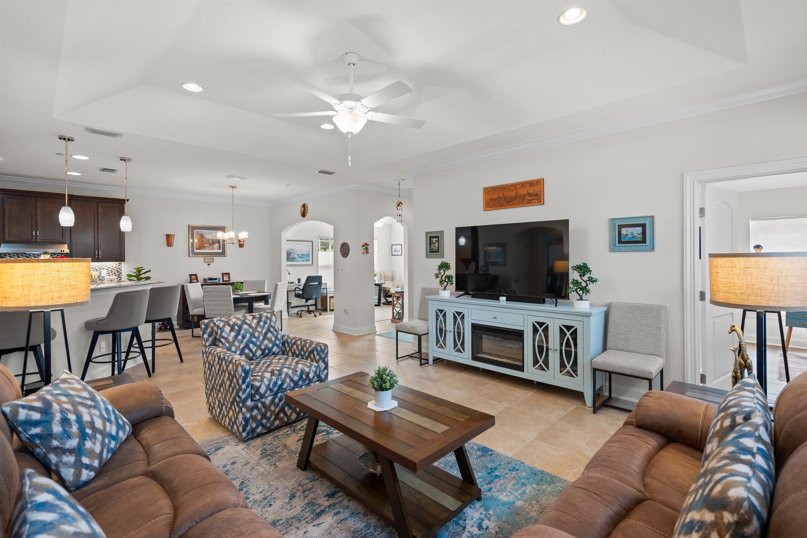 102 Timoga Trail St. Augustine, FL 32084 - Photo 9 of 44 a living room with furniture a flat screen tv and kitchen view