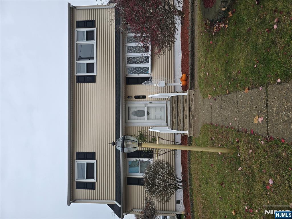 18 Donna Drive, Unit 2 Wood-Ridge, NJ 07075 - Photo 1 of 15 a front view of a house with a yard