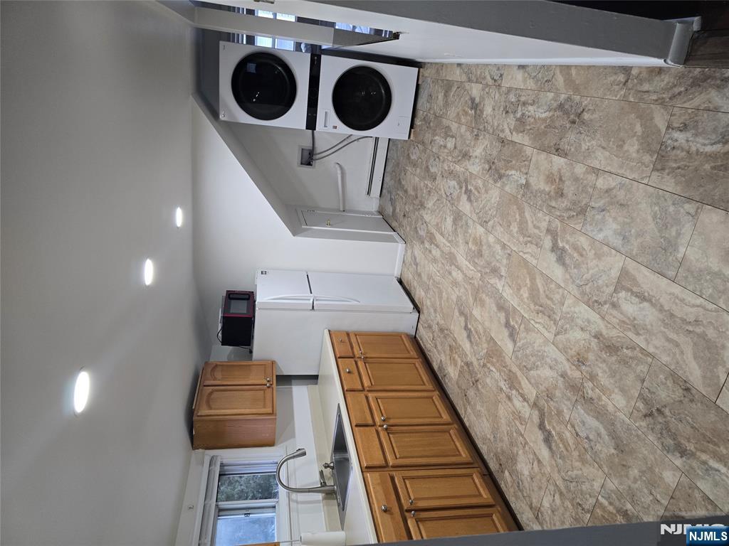 18 Donna Drive, Unit 2 Wood-Ridge, NJ 07075 - Photo 11 of 15 a large white kitchen with a sink and cabinets
