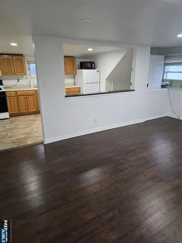 a view of a kitchen with wooden floor and a sink