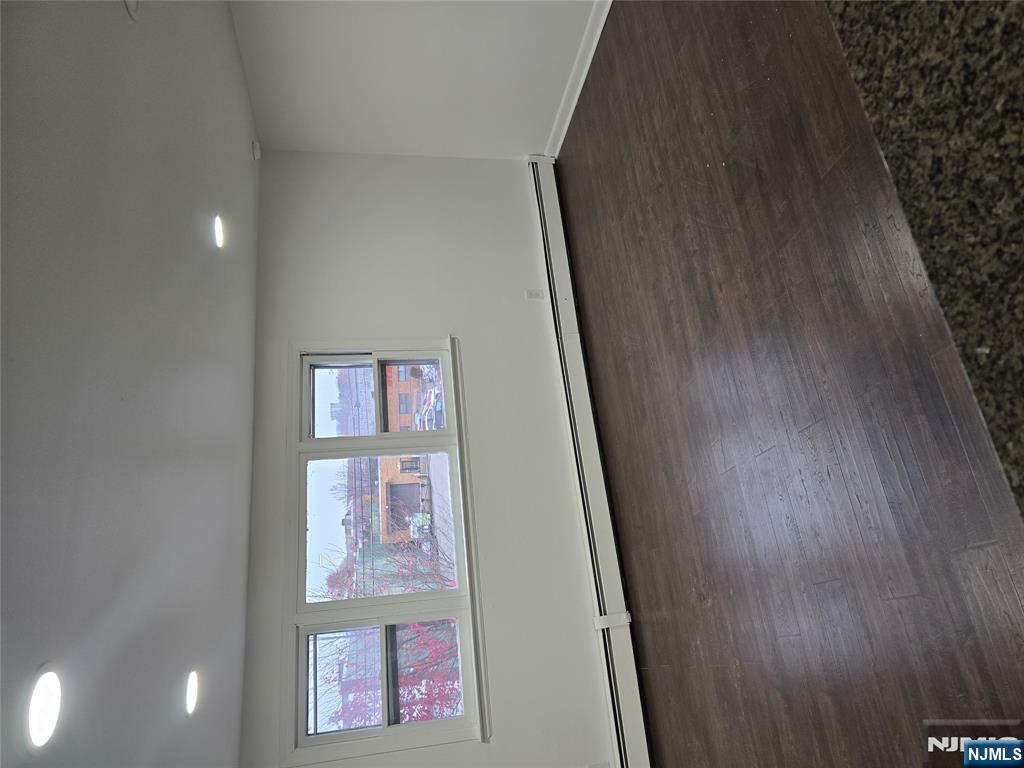 18 Donna Drive, Unit 2 Wood-Ridge, NJ 07075 - Photo 14 of 15 an empty room with wooden floor and window