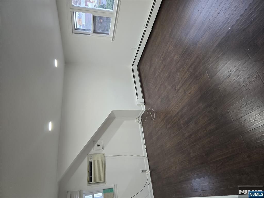 18 Donna Drive, Unit 2 Wood-Ridge, NJ 07075 - Photo 15 of 15 an empty room with wooden floor and windows