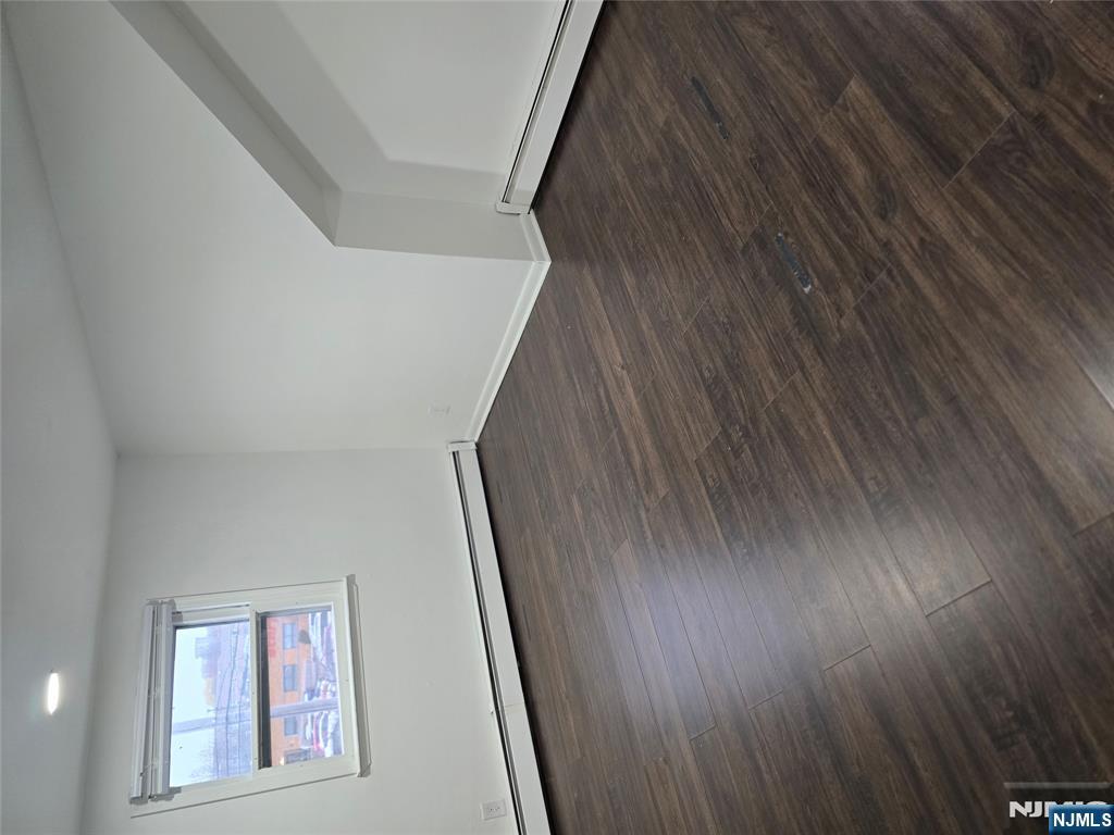 18 Donna Drive, Unit 2 Wood-Ridge, NJ 07075 - Photo 2 of 15 an empty room with wooden floor and windows