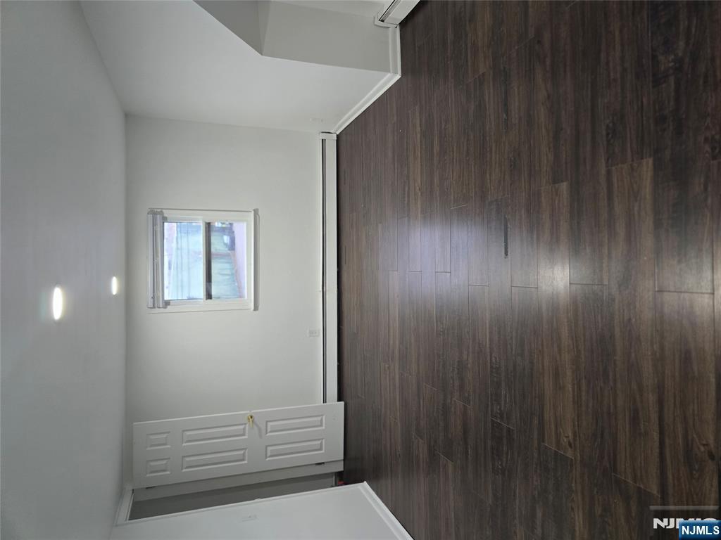 18 Donna Drive, Unit 2 Wood-Ridge, NJ 07075 - Photo 3 of 15 an empty room with wooden floor and windows