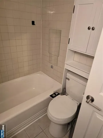 a bathroom with a toilet and shower