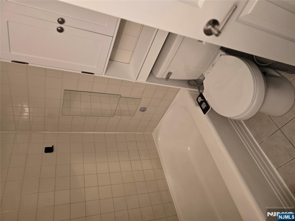 18 Donna Drive, Unit 2 Wood-Ridge, NJ 07075 - Photo 6 of 15 a bathroom with a toilet and shower