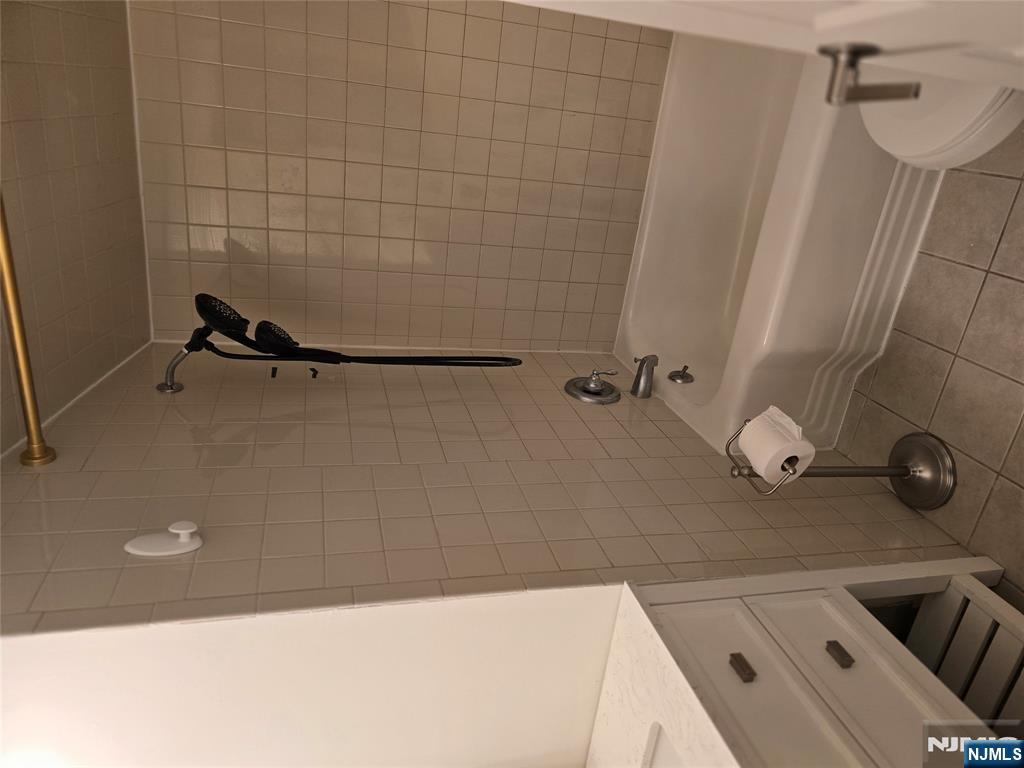 18 Donna Drive, Unit 2 Wood-Ridge, NJ 07075 - Photo 7 of 15 a bathroom with a bathtub and a shower