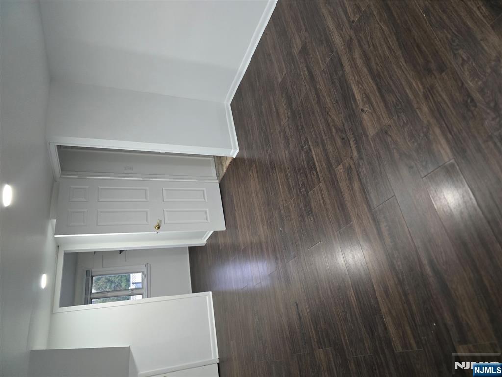 18 Donna Drive, Unit 2 Wood-Ridge, NJ 07075 - Photo 8 of 15 an empty room with wooden floor and windows