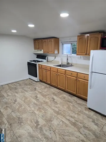 a kitchen with stainless steel appliances granite countertop a refrigerator sink and cabinets