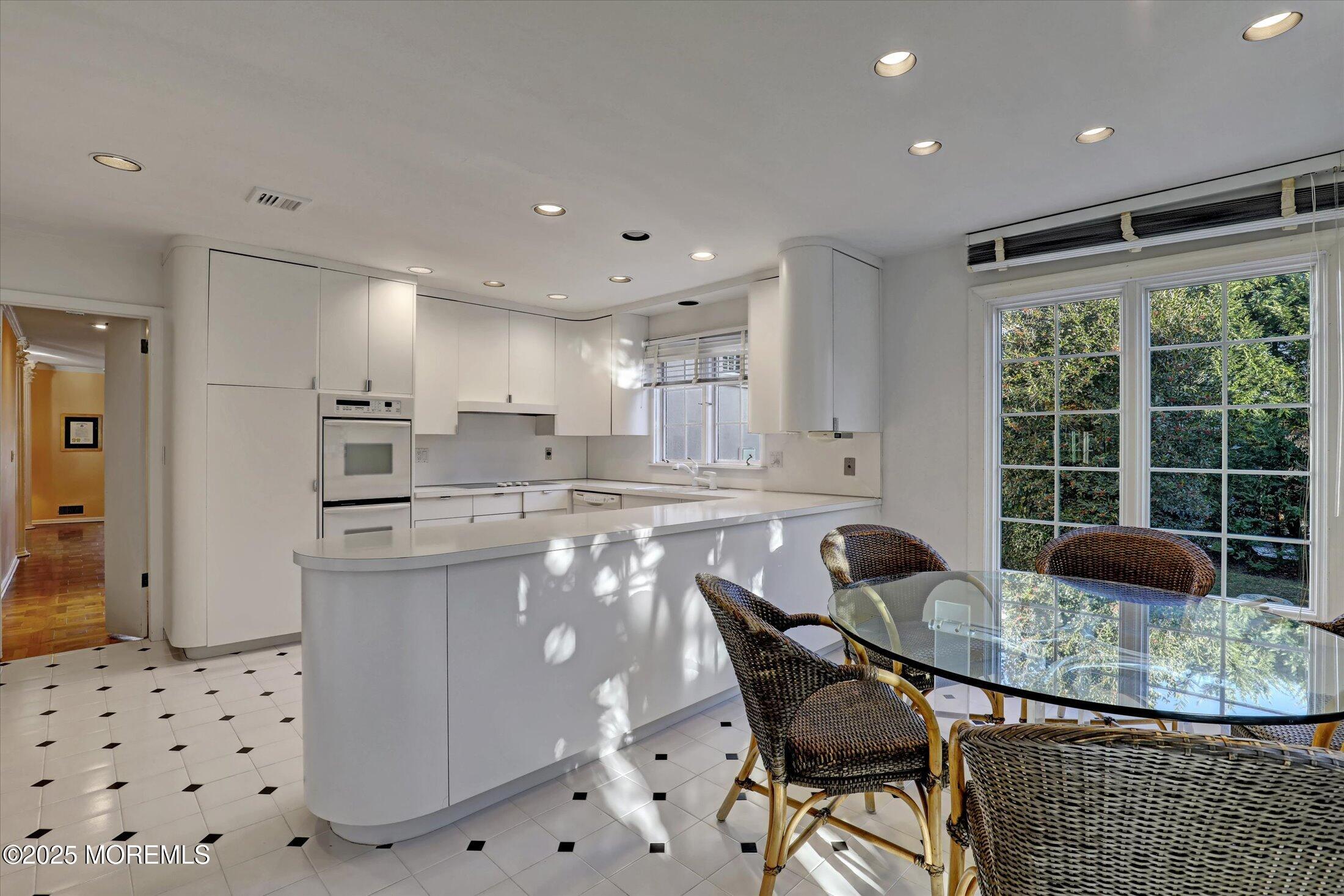 12 Woodford Road Deal, NJ 07723 - Photo 18 of 77 a kitchen with granite countertop kitchen island stainless steel appliances a table and chair