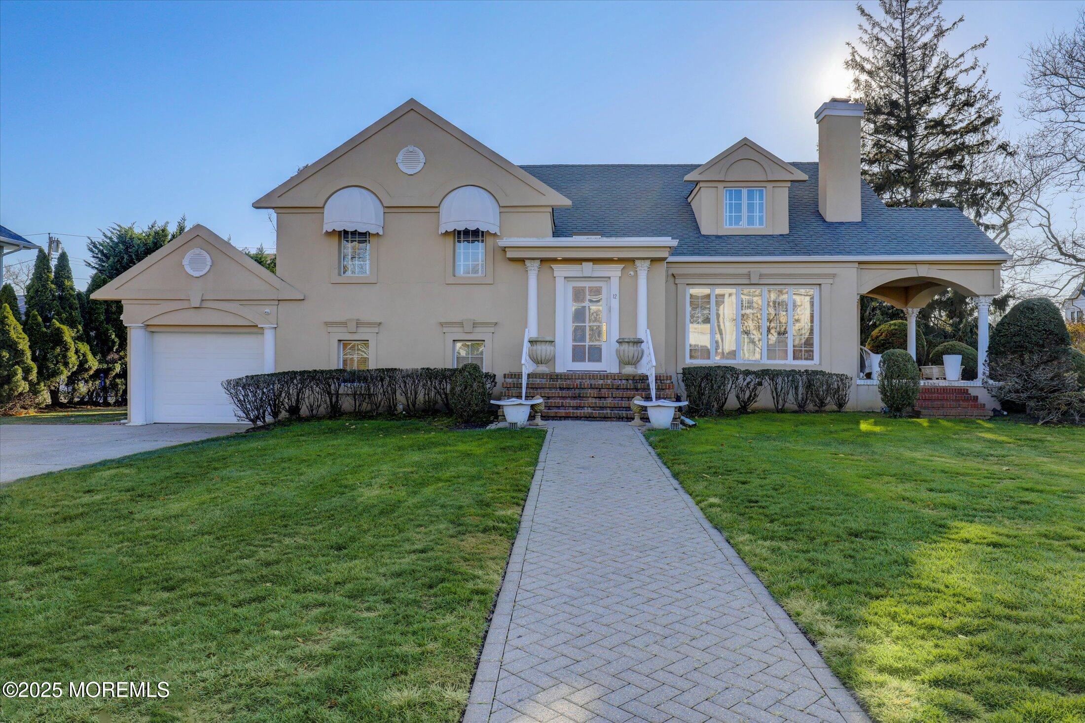 12 Woodford Road Deal, NJ 07723 - Photo 2 of 77 a front view of a house with a garden