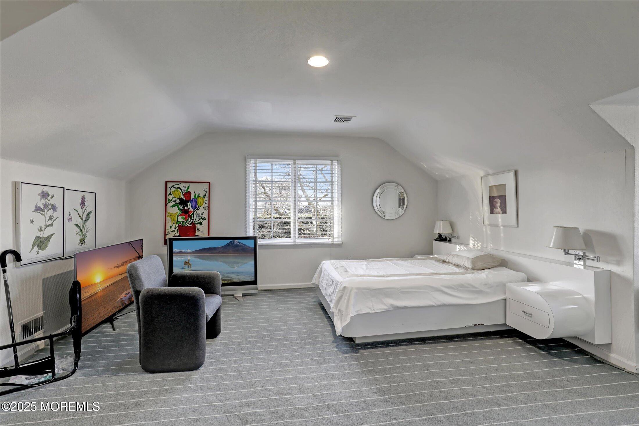 12 Woodford Road Deal, NJ 07723 - Photo 39 of 77 a bedroom with a bed and wooden floor