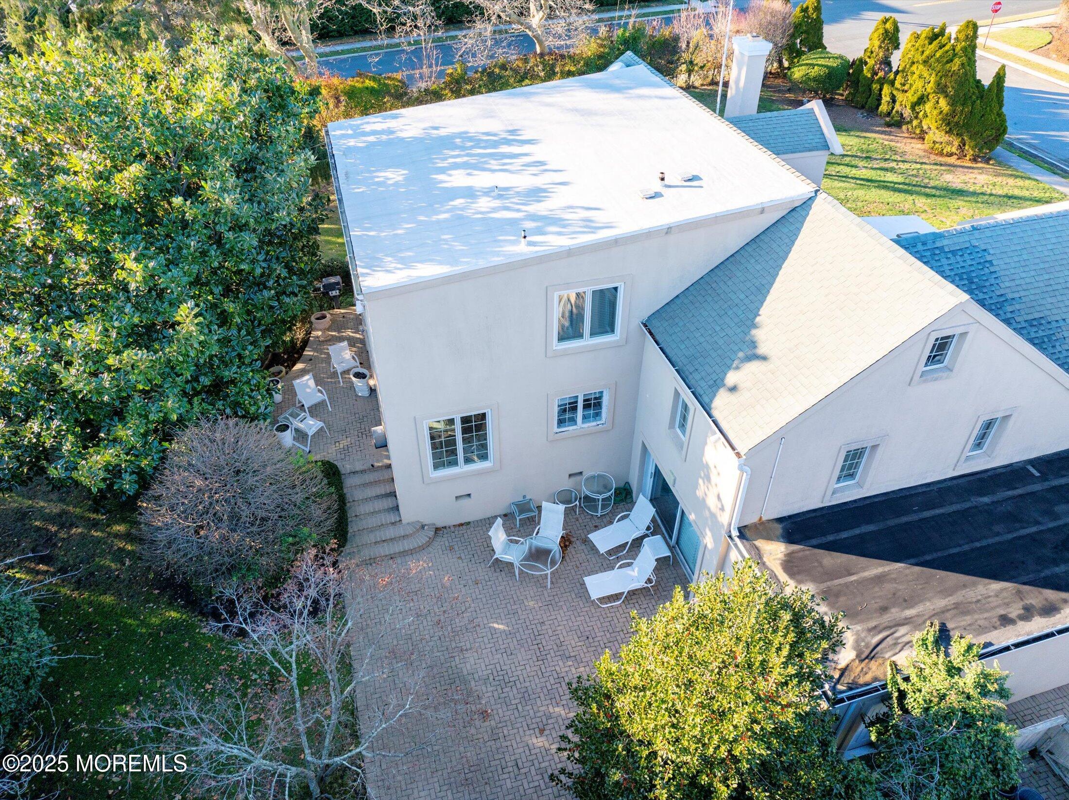 12 Woodford Road Deal, NJ 07723 - Photo 60 of 77 a view of a patio with table and chairs potted plants