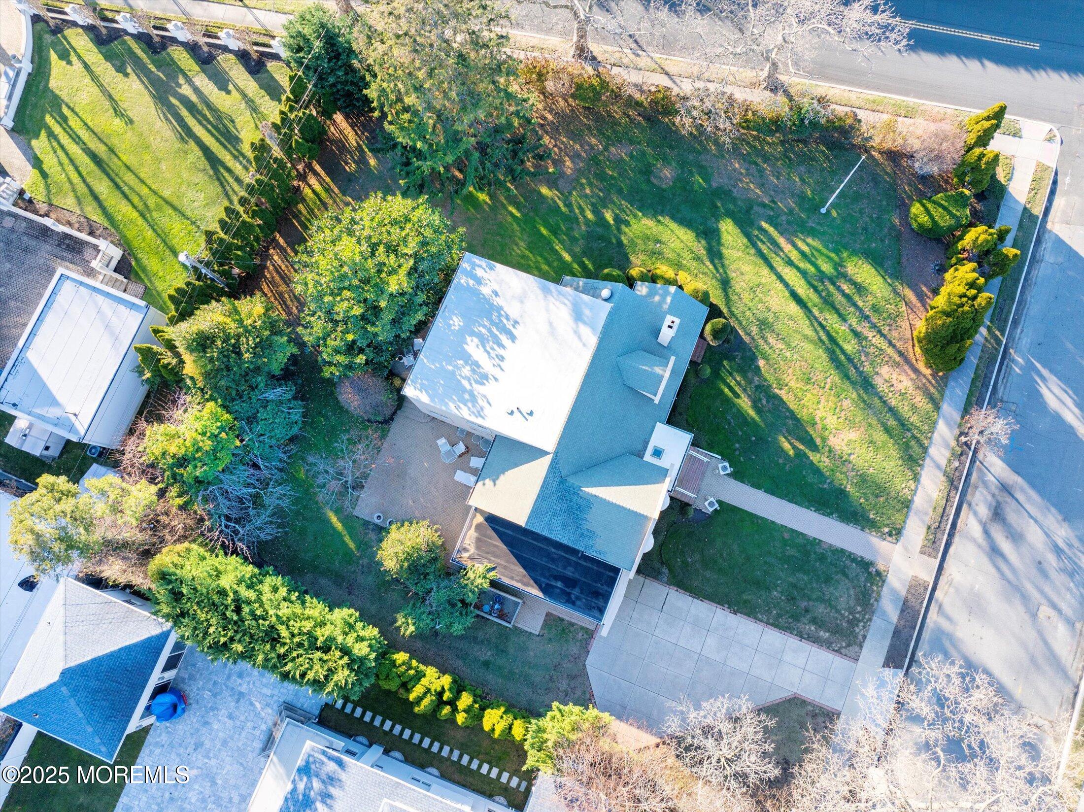 12 Woodford Road Deal, NJ 07723 - Photo 64 of 77 an aerial view of a house with a yard and garden