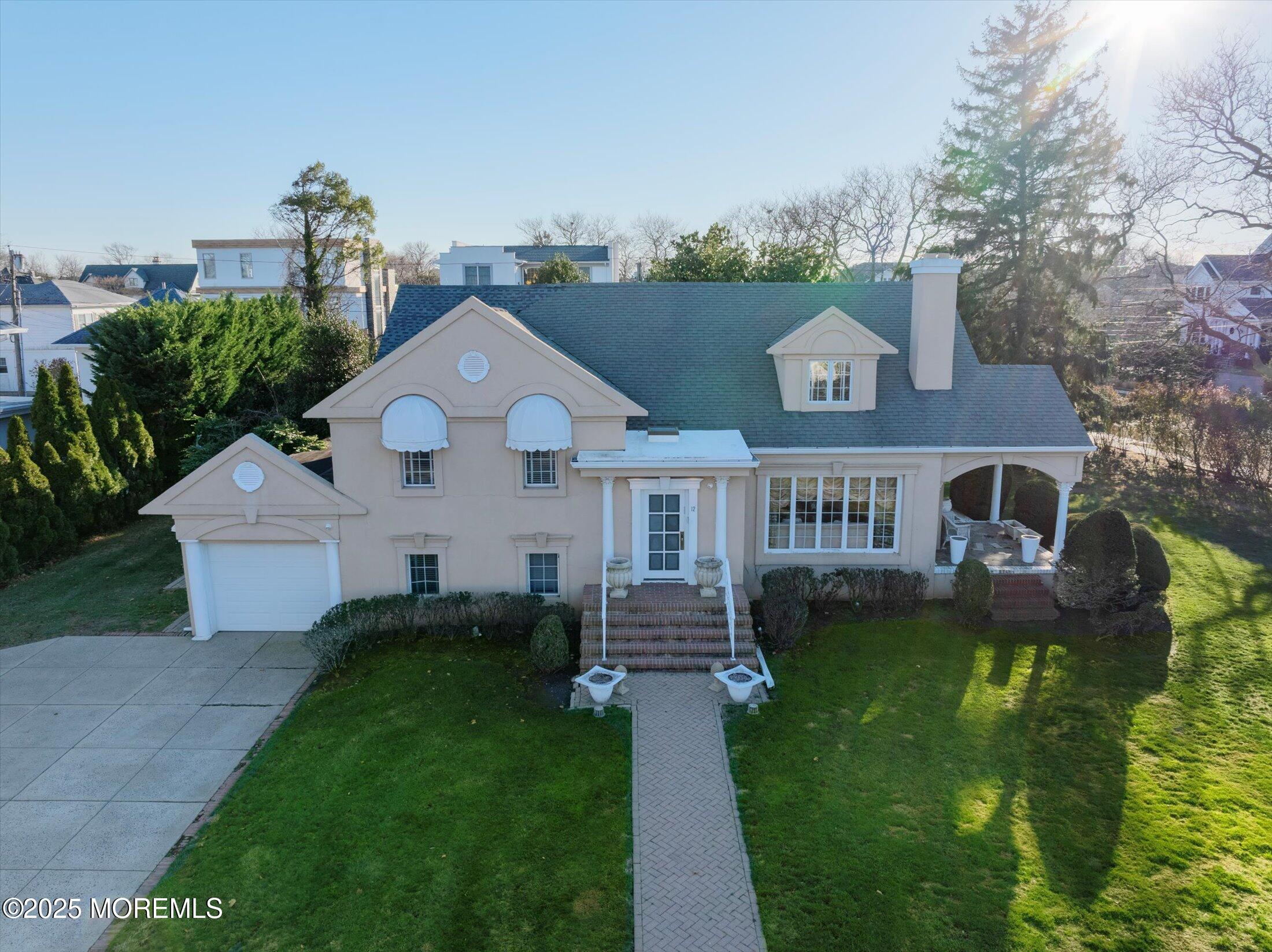 12 Woodford Road Deal, NJ 07723 - Photo 7 of 77 a front view of a house with a garden and plants