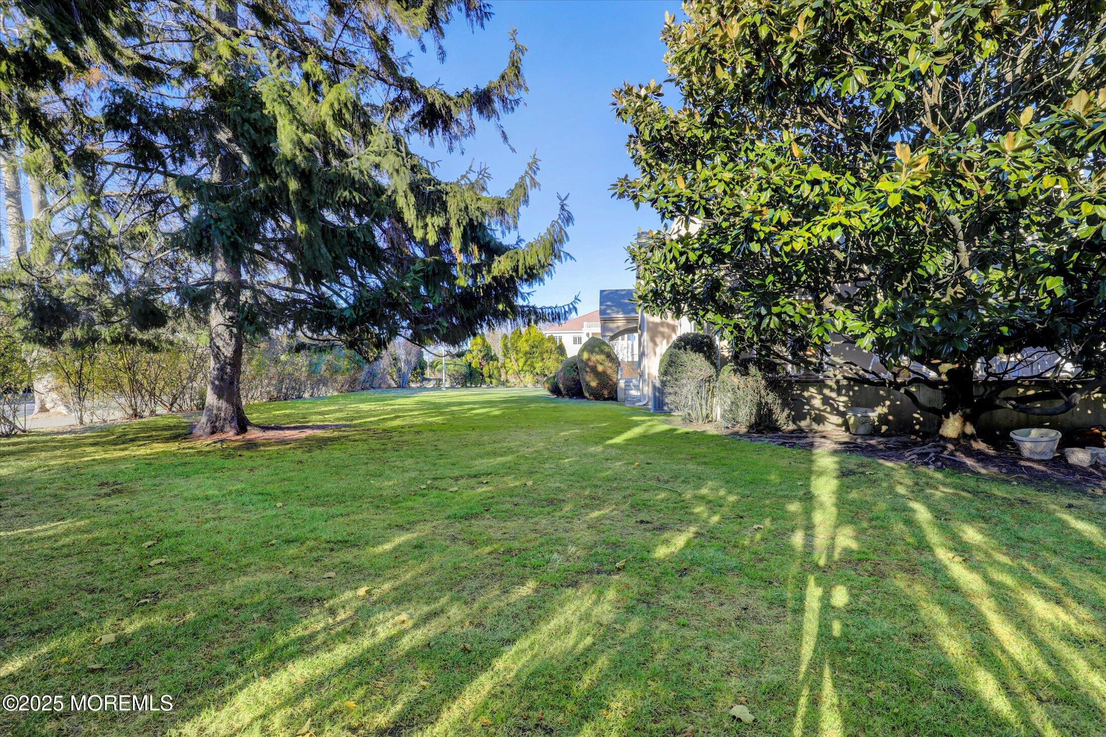 12 Woodford Road Deal, NJ 07723 - Photo 74 of 77 a backyard of a house with lots of green space