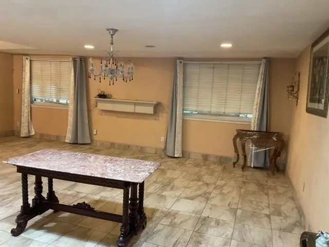 a view of kitchen with furniture and refrigerator
