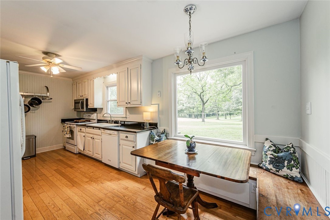 7300 Old Roxbury Road Quinton, VA 23141 - Photo 23 of 89 Kitchen featuring wood-finish flooring, white cabi
