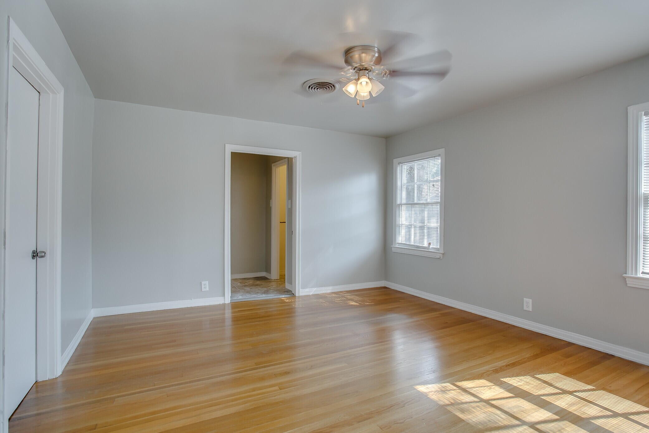 2412 22nd Street Lubbock, TX 79411 - Photo 14 of 18 a view of an empty room with wooden floor and a window