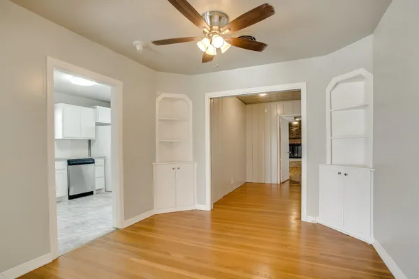 a kitchen with white cabinets stainless steel appliances and sink