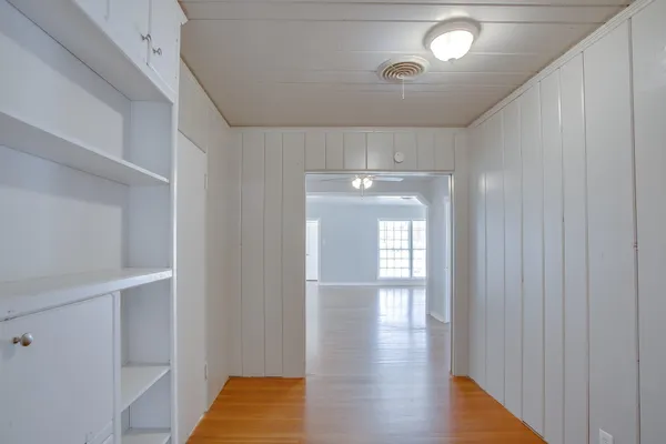an empty room with windows and fireplace
