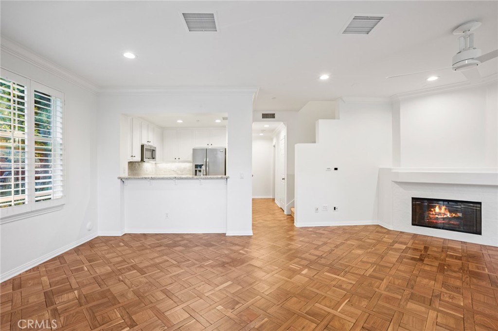 121 Danbrook Irvine, CA 92603 - Photo 3 of 16 a view of kitchen and empty room with windows
