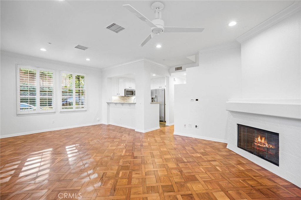 121 Danbrook Irvine, CA 92603 - Photo 4 of 16 a view of an empty room with a fireplace and a window