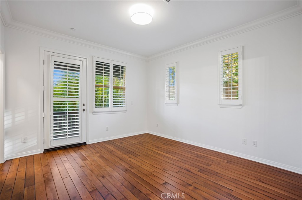 121 Danbrook Irvine, CA 92603 - Photo 8 of 16 an empty room with wooden floor and windows