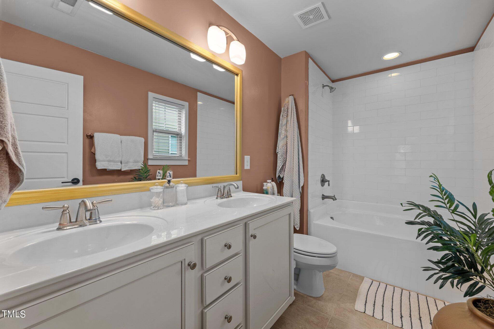 7837 Allscott Way Raleigh, NC 27612 - Photo 12 of 17 a bathroom with a granite countertop sink toilet and shower