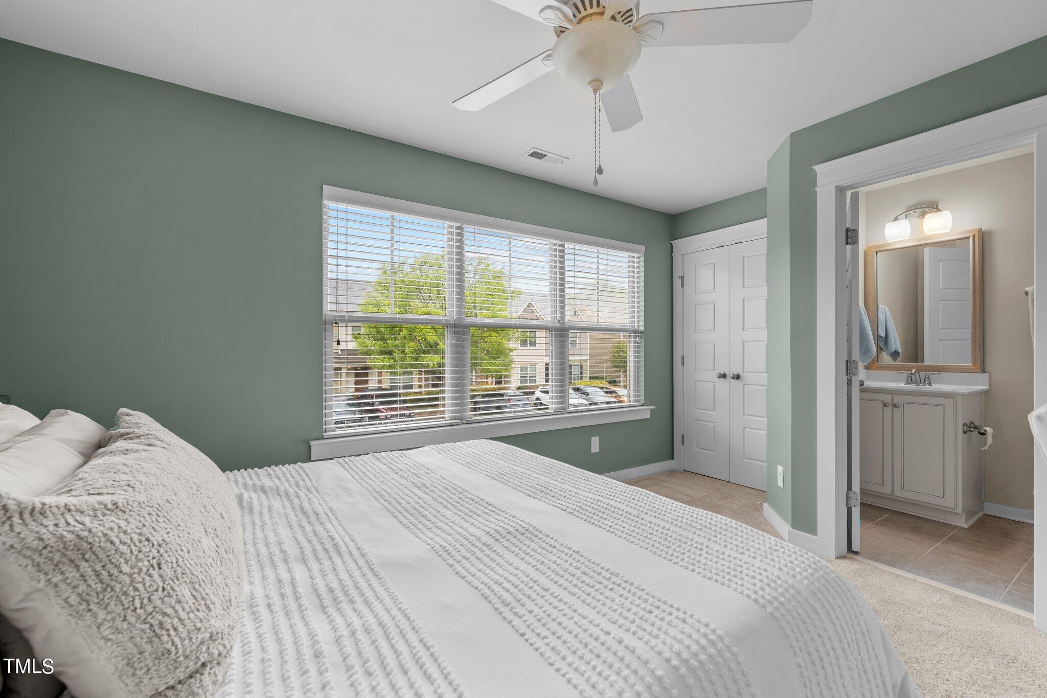7837 Allscott Way Raleigh, NC 27612 - Photo 13 of 17 a bedroom with a large bed and a chandelier