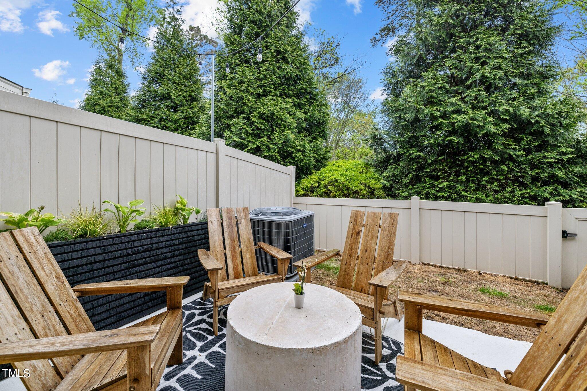 7837 Allscott Way Raleigh, NC 27612 - Photo 15 of 17 a view of an outdoor sitting area with brick walls