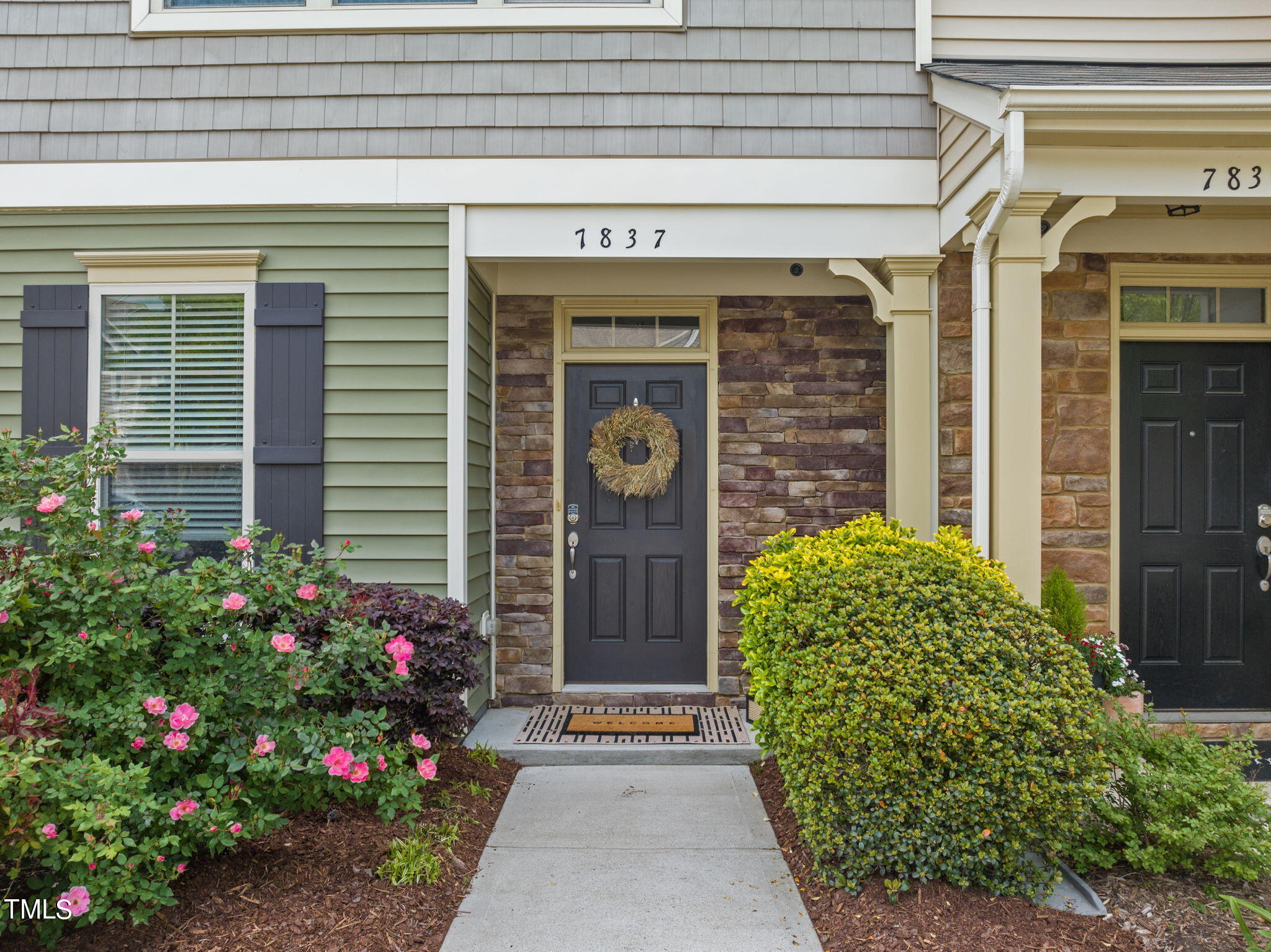 7837 Allscott Way Raleigh, NC 27612 - Photo 2 of 17 a front view of a house with garden