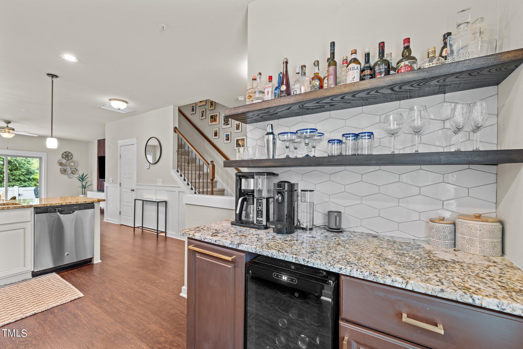 7837 Allscott Way Raleigh, NC 27612 - Photo 5 of 17 a kitchen with stainless steel appliances granite countertop a sink stove and cabinets