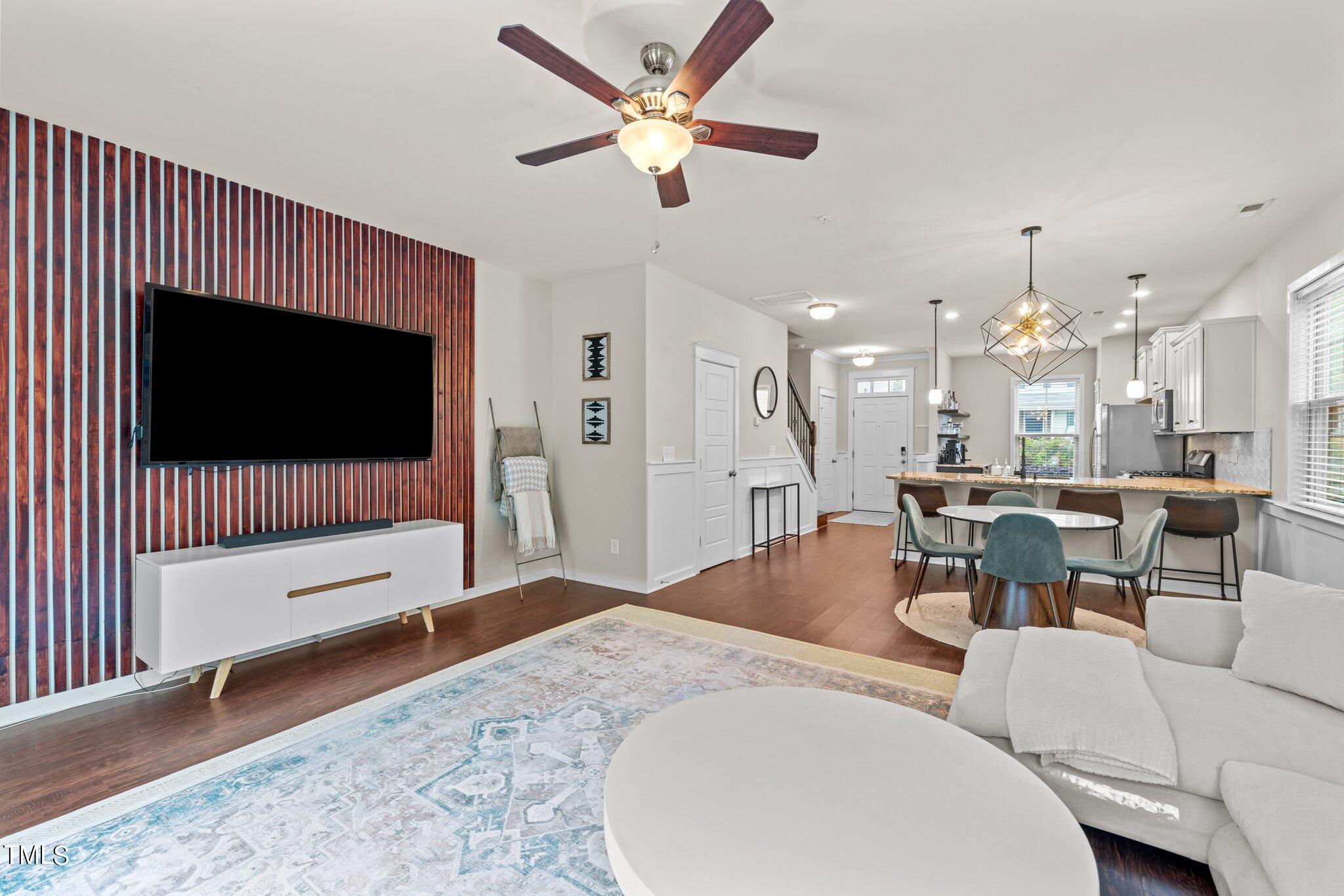 7837 Allscott Way Raleigh, NC 27612 - Photo 8 of 17 a living room with furniture and a flat screen tv