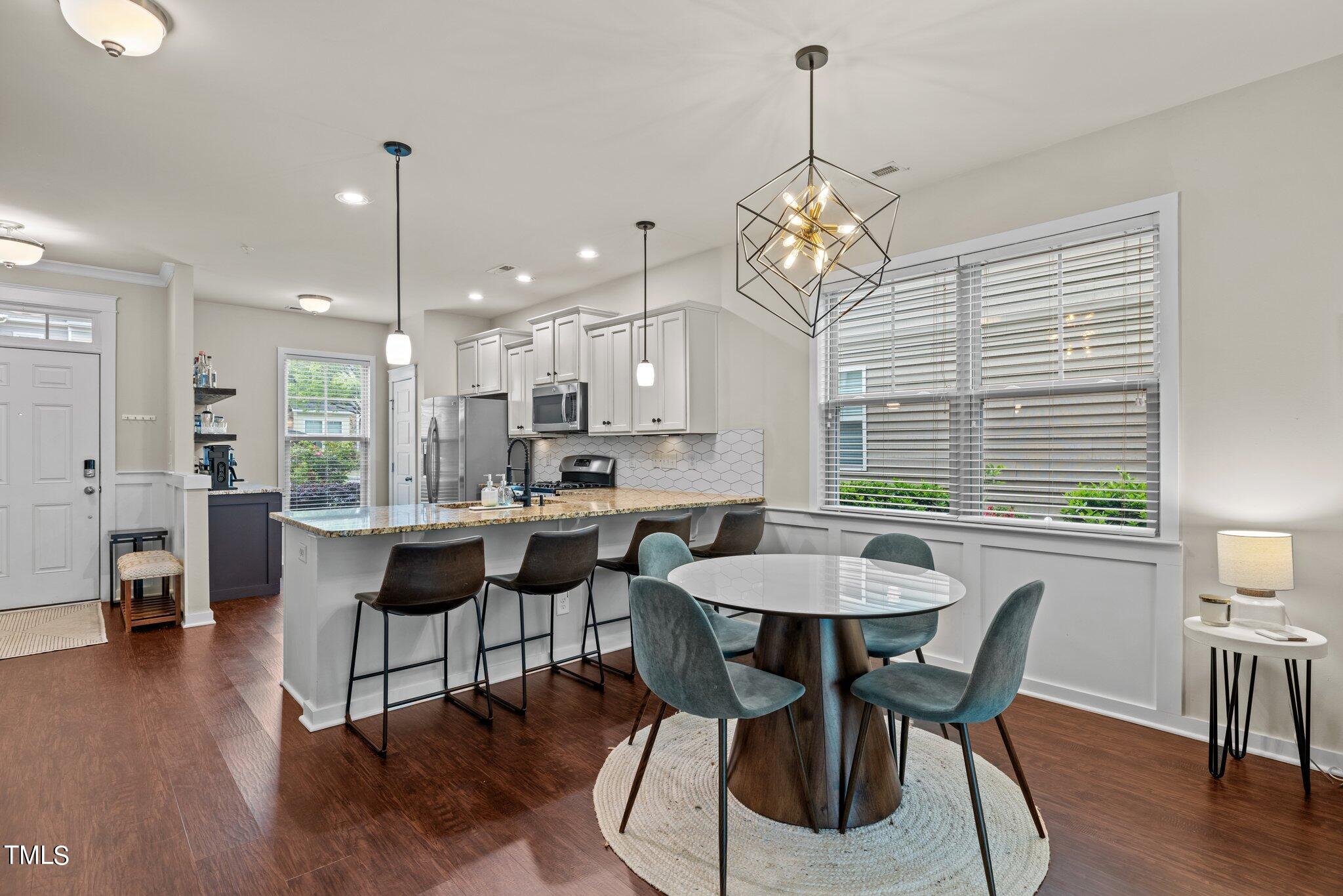 7837 Allscott Way Raleigh, NC 27612 - Photo 9 of 17 a view of a dining room with furniture window and wooden floor