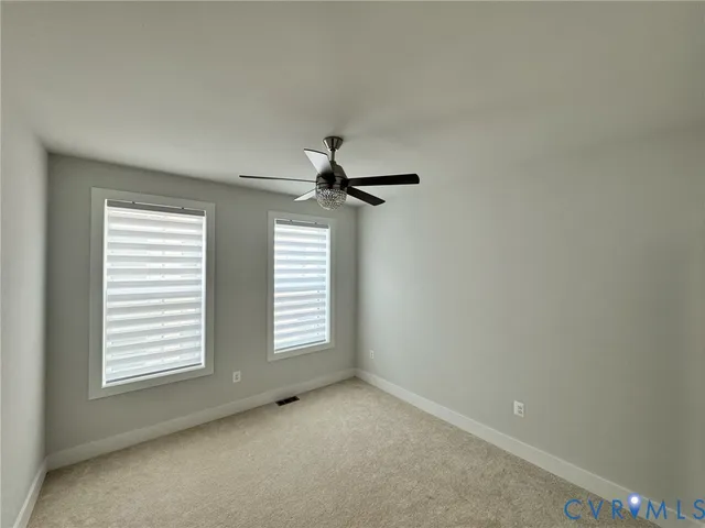 a view of room with a ceiling fan and window