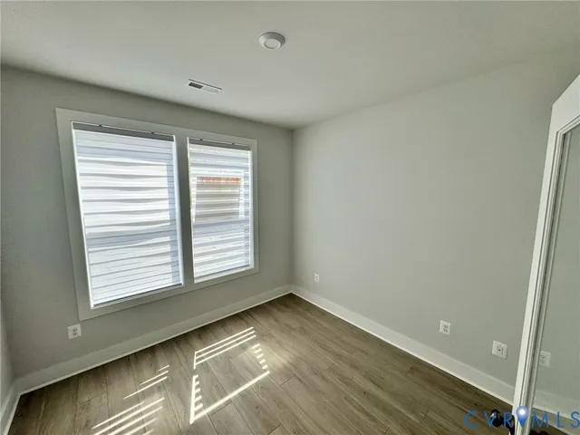 a view of a room with a ceiling fan window and a ceiling fan