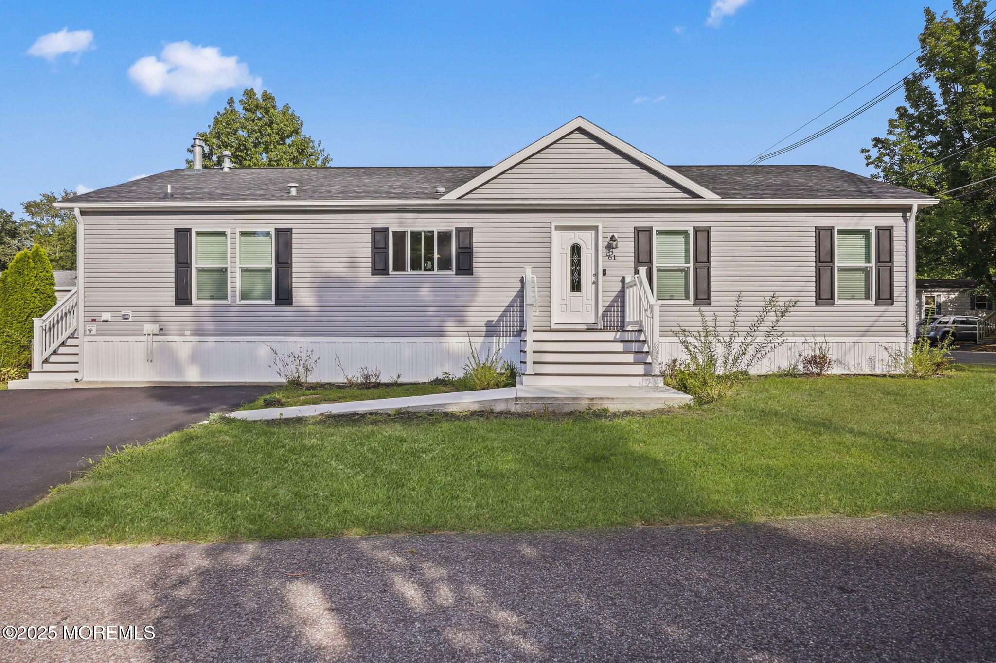 61 Village Road Morganville, NJ 07751 - Photo 1 of 2 a front view of a house with a yard