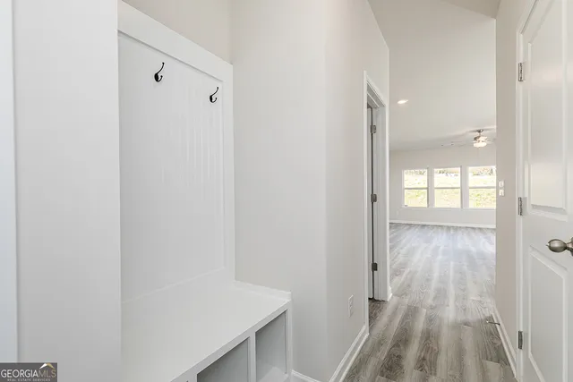 a view of a hallway with wooden floor
